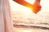 Love - romantic couple holding hands, beach sunset