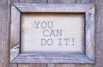 Can I Handle This? You can do it written on wooden frame, close-up